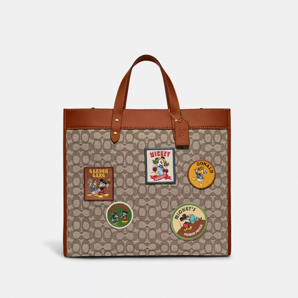 DISNEY X COACH FIELD TOTE 40 IN SIGNATURE TEXTILE JACQUARD WITH PATCHES 3 DISNEY X COACH FIELD TOTE 40 IN SIGNATURE TEXTILE JACQUARD WITH PATCHES