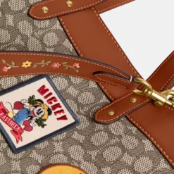 DISNEY X COACH FIELD TOTE 40 IN SIGNATURE TEXTILE JACQUARD WITH PATCHES 15 DISNEY X COACH FIELD TOTE 40 IN SIGNATURE TEXTILE JACQUARD WITH PATCHES -Fashion Comprehensive cg974 txt a99